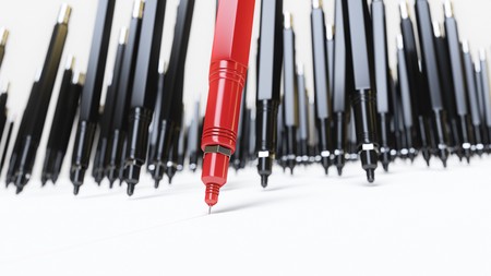 Red finepoint technical drawing pen leading a pack of monotonous black similar pens as they all draw line on a white surface. This image is a 3d rendering.の写真素材