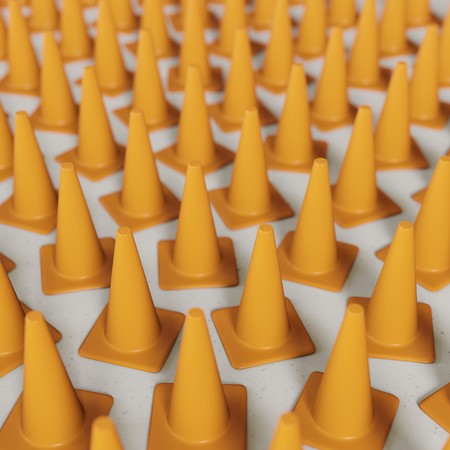 Numerous unmarked orange traffic cones on concrete. This image is a 3d rendering an features a shallow depth of field.の写真素材