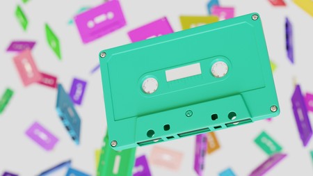 Floating White Cassette Tape against a white background and array of out of focus Cassette Tapes of...