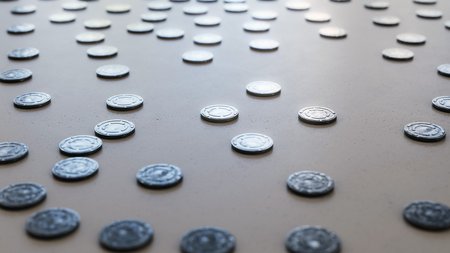 Large scattered array of steel film reel cans arranged on a minimally textured white concrete surface. This image is a 3d rendering.の写真素材