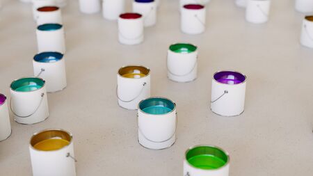 Large scattered array of black oil barrels arranged on a minimally textured white concrete surface. This image is a 3d rendering.の写真素材