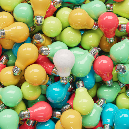Subtly scratched white light bulb on a pile of brightly colored light bulbs. This image is a 3d render.の写真素材