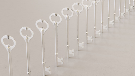 Close up on a tightly packed, perfectly aligned linear array of variously colored classic keys on a simple modernist neutral surface. This image is a 3d render.の写真素材