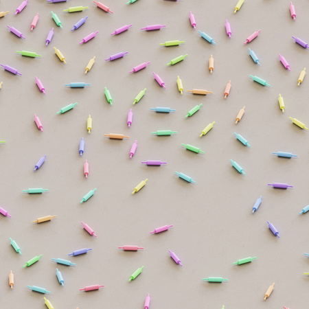 Playfully scattered rolling pins of various colors on a clean white concrete studio floor. This image is a 3d illustration.の写真素材