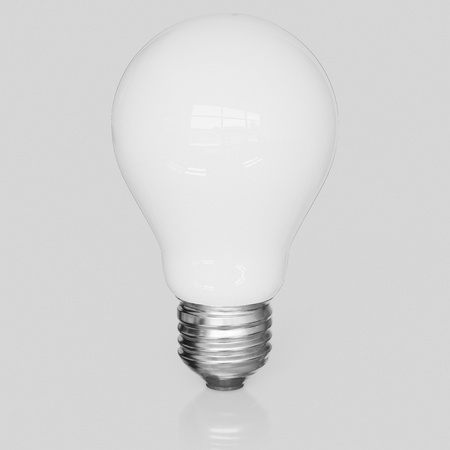 3d rendered White Light bulb on a seamless reflective white surface for easy compositing.の写真素材