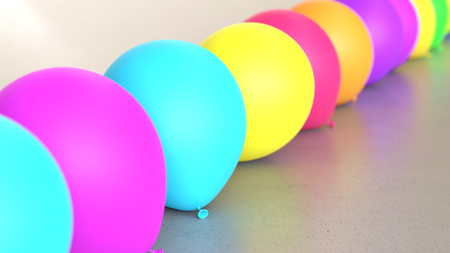 Line of Vibrantly Colored Balloons on Simple Light Grey Surfaceの写真素材
