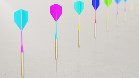 Line of Vibrantly Colored Playing Darts on Simple Light Grey Surfaceの写真素材