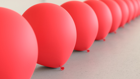 Linear Array of Red Balloons on a Light Gray Surfaceの写真素材