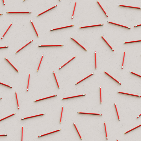 Isometric Red Pencils in a Tight Grid on a Simple Concrete Surfaceの写真素材