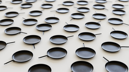 Iron Frying Pans in an Even Grid on a Simple Concrete Surfaceの写真素材