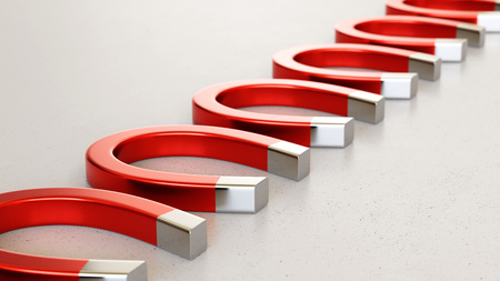 Linear Array of Red Magnets on a Light Gray Surfaceの写真素材