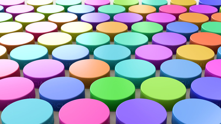 Variously Colored Hockey Pucks in a Tight Even Grid on a Simple Concrete Surfaceの写真素材