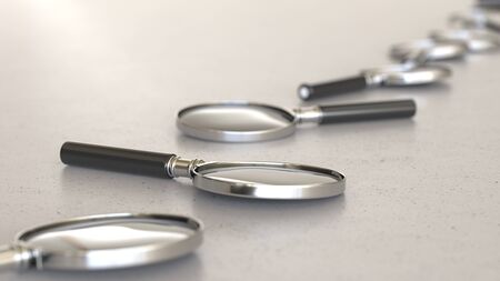 Line of Vibrantly Colored Magnifying Glass' on Simple Light Grey Surfaceの写真素材
