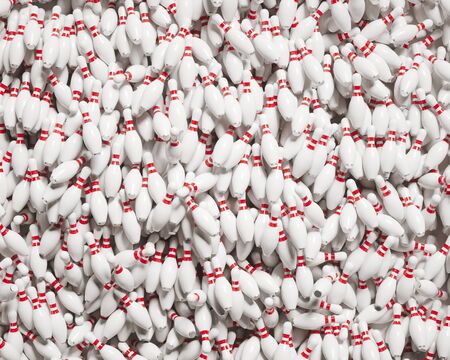 Partially aligned huge pile of many red and white bowling pins under bright lighting.  This image is a 3d render.の写真素材