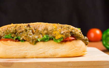 Delicious Chicken Burger Steak Supreme with Lettuce And Tometo Served on Wooden Table on Dark Background.の写真素材