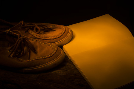 shoes with notebook on wooden backgroundの写真素材