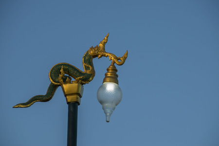Golden Naga Thai traditional street lamp.The king of snake lamppost with blue sky in Thailand, Asia.の写真素材