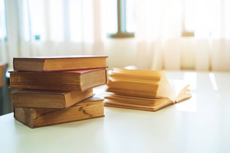 Book stack on table in the library room, business and education background concept の写真素材