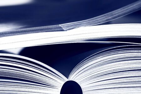 Opened books on blue backgroundの写真素材