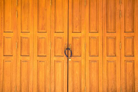 Old rusty lock on wooden door closeupの写真素材