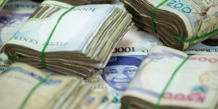 Rolls and Bundles of Naira Cash local currencies in a pyramid heap