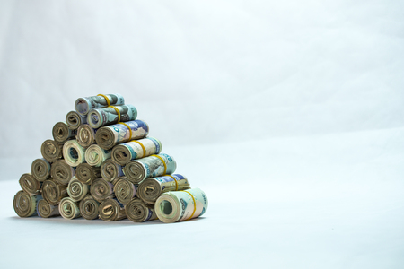 Rolls and Bundles of Naira Cash local currencies in a pyramid heapの写真素材