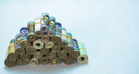 Rolls and Bundles of Naira Cash local currencies in a pyramid heapの写真素材