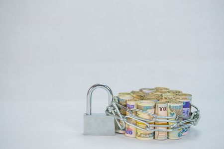 Bundles of naira cash chained and padlock concept of Esecurity on white backgroundの写真素材