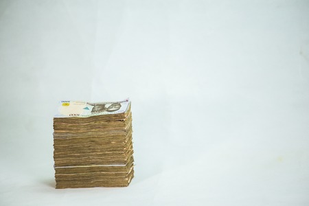 Stack of nigeria naira notes on white backgroundの写真素材