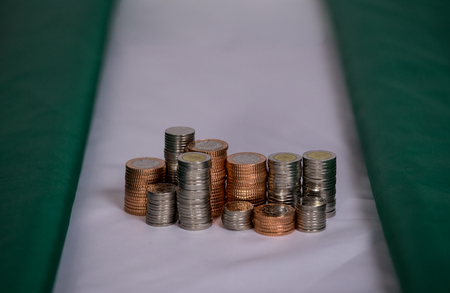 nigeria flag with coins in a stackの写真素材
