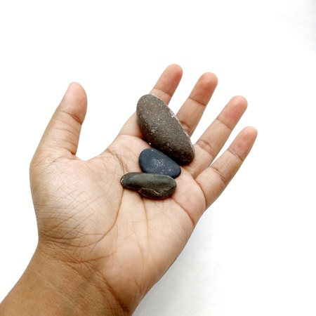 Hand holding stone.の写真素材