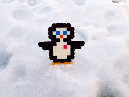 plastic penguin with heart in the snowの写真素材