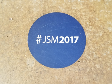 blue sticker on the ground that says JSM2017