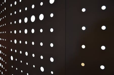 bright white circular lights on a wall or backgroundの写真素材