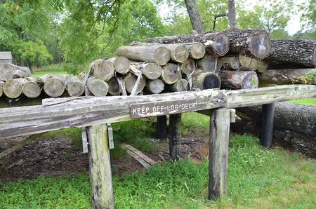 keep off log deck sign with wood structure and logs or tree trunks