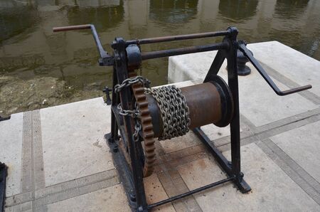metal chain on hand crank reel or spool and water