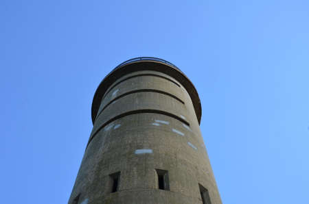 tall cement tower structure with blue sky