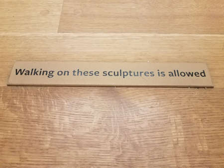 walking on sculptures allowed sign on wood floor