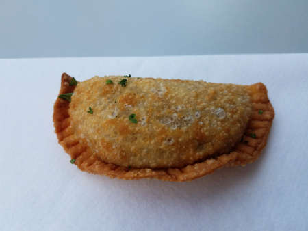 fried Puerto Rican empanada appetizer snack on paper towel