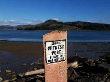 survey witness post please do not disturb sign and waterの写真素材