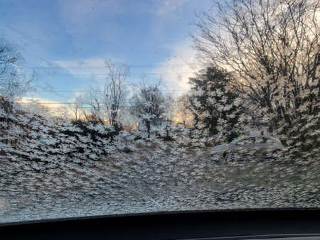 frozen water ice crystals on car window in winterの写真素材