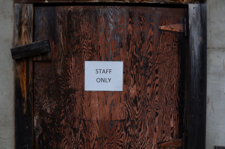 closed red and black door with staff only signの写真素材