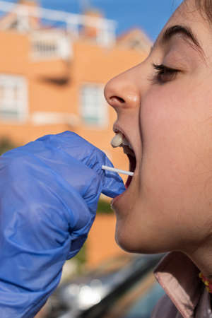 girl with a mask taking the covid-19 testの写真素材