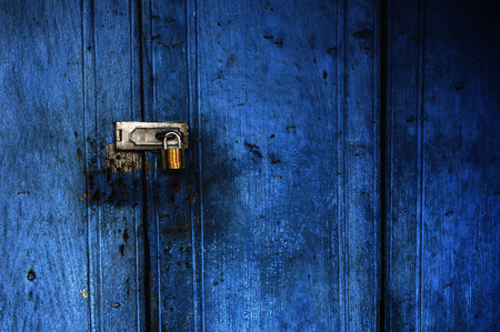 Blue door lock with keyの写真素材