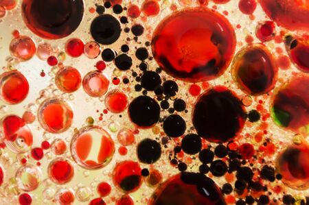 abstract colorful background, red oil drops on waterの写真素材