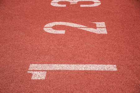 Running track closeup numbers one in stadium