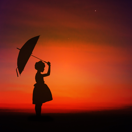 Umbrella little girl stand and sunset silhouette.の写真素材