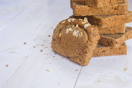 Fresh whole grain bread on white wood background