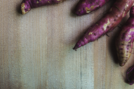 Purple Sweet Potatoes on a wooden table,Healthy food.の写真素材