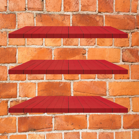 3 Red Wood Shelves Table on brick wall  backgroundの写真素材